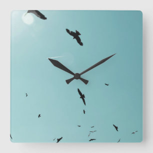 Many birds and a contrail square wall clock