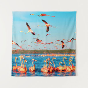 Many pink beautiful flamingos in a beautiful blue  tapestry
