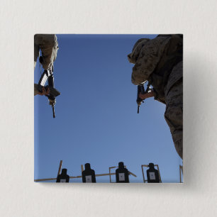 Marines change magazines in the midst of firing 2 inch square button