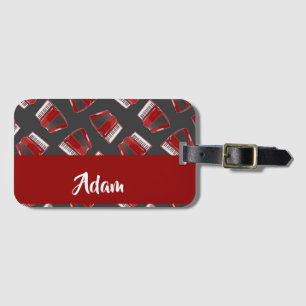 Maroon accordion on grey luggage tag