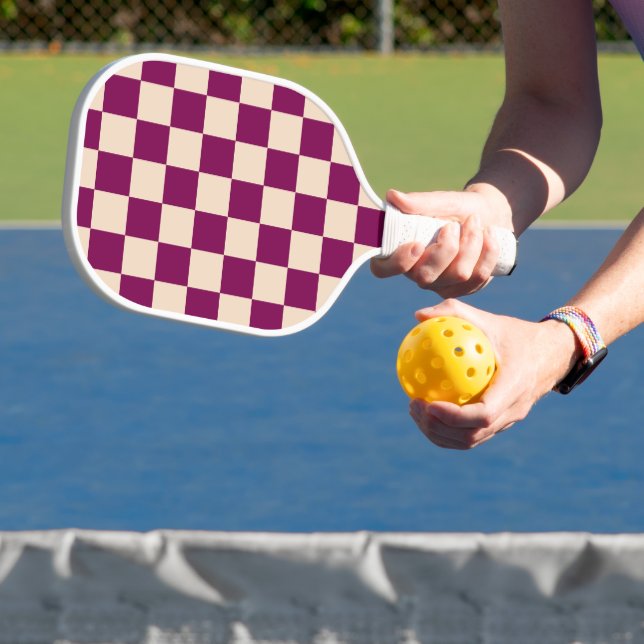 Maroon and beige chequerboard pattern pickleball paddle (Insitu)