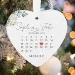 Married Christmas Wedding Date Heart Script Ornament<br><div class="desc">Celebrate love with our Heart-Shaped Married Ornament, the perfect Wedding Gift for newlyweds! This Ceramic Wedding Date Ornament features an elegant script on a clean white background, with delicate floral details of white roses and sage green leaves, and a vibrant red heart marking your special wedding day on the calendar....</div>