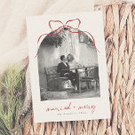Married & Merry Elegant Bow Arch Photo Christmas Holiday Card<br><div class="desc">Celebrate your first holiday season as newlyweds with these elegant Christmas photo cards. The design highlights an arch-shaped photo topped with a whimsical hand-drawn red bow, with ‘married merry’ in modern script lettering below. A black-and-white filter is shown on the sample photo, but you can easily customize or remove it...</div>