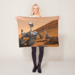 Mars Science Laboratory Curiosity Rover. Fleece Blanket<br><div class="desc">Artist concept of Mars Science Laboratory Curiosity rover, a mobile robot for investigating Mars' past or present ability to sustain microbial life. In this picture, the rover examines a rock on Mars with a set of tools at the end of the rover's arm, which extends about 7 feet. Two instruments...</div>