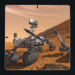 Mars Science Laboratory Curiosity Rover. Square Wall Clock<br><div class="desc">Artist concept of Mars Science Laboratory Curiosity rover, a mobile robot for investigating Mars' past or present ability to sustain microbial life. In this picture, the rover examines a rock on Mars with a set of tools at the end of the rover's arm, which extends about 7 feet. Two instruments...</div>