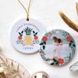 Mele Kalikimaka | Hawaiian Christmas Photo Ceramic Ornament<br><div class="desc">Festive holiday ornament features a Christmas pineapple illustration flanked by red poinsettia flowers and green holly,  with the Hawaiian Christmas greeting "Mele Kalikimaka" curved above. Personalize with the year for a tropical chic holiday keepsake,  and add a favourite photo to the reverse side,  surrounded by matching lorals and branches.</div>