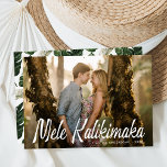 Mele Kalikimaka Modern Photo Holiday Card<br><div class="desc">Send warm wishes and holiday greetings Hawaiian-style with our modern Mele Kalikimaka photo card. The tropical-themed Christmas card features "Mele Kalikimaka" displayed in white tiki-style lettering overlaying your horizontal photo. Personalize the card with your family name and the year. The card reverses to a tropical leaf pattern.</div>