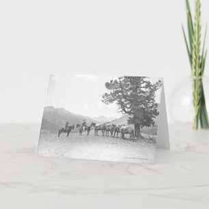 Men with packhorses looking over a hill card
