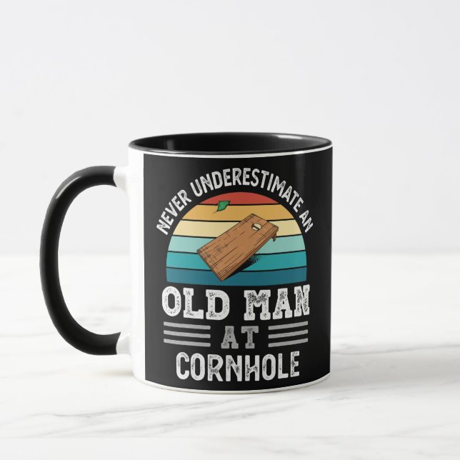 Mens Never underestimate an Old Man at Cornhole Mug (Left)