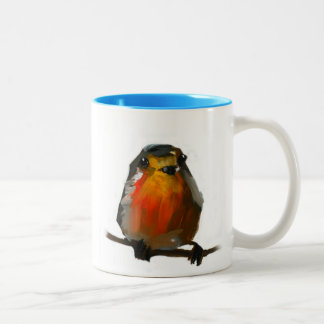 merle sur la tasse de branche avec le