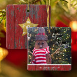 Merry and Bright Cute Rustic Snowman Tree Keepsake Ceramic Ornament<br><div class="desc">“May your days be merry & bright.” A close-up photo of a happy and cute, rustic log snowman, wrapped in a red and white striped scarf against lighted trees helps you usher in Christmas and New Year. On the back, a gold faux glitter star overlays dark red barn wood. Feel...</div>