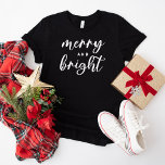 Merry and Bright Modern Black Women's Christmas T-Shirt<br><div class="desc">A festive Christmas graphic tee for women featuring modern lowercase script typography with "Merry and Bright" saying. White text and black tshirt style can both be modified.</div>