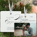 Merry and Engaged Photo and Elegant Calligraphy Ceramic Ornament<br><div class="desc">Merry & Engaged Christmas photo ornament which you can personalize with your favourite photo and persoanlized wording. Elegant typographic design with swirly calligraphy and easy to edit for an engaged couple. This holiday ornament is lettered with Merry & Engaged on one side and editable text on the other. The sample...</div>