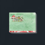 Merry ChrisMUSH Cartoon Mushrooms Post-it Notes<br><div class="desc">Use these cute cartoon mushroom caps (wearing caps) for fun holiday notes. Text (that can be customized) reads: Merry ChrisMUSH! These have a textured watercolor pattern in green on the paper and a candy cane narrow border on the bottom in red and white. Spread the cheer! Happy Holidays!</div>