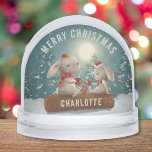 Merry Christmas Cute Winter Rabbits Personalized Snowglobe<br><div class="desc">Merry Christmas Cute Winter Rabbits Personalized Snow Globes features cute rabbits drinking coffee sitting on a log in the snow with Christmas trees and the moon in the background with the text "Merry Christmas" in modern script typography with your custom name on the log. Personalize by editing the text in...</div>