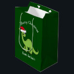 Merry Christmas Dinosaur in Santa Hat Custom Kids Medium Gift Bag<br><div class="desc">Cute holiday animals are my favourite part of Christmas. A cool green dinosaur wearing a red Santa hat and looking happy. This personalized kids gift bag fills me with the Christmas spirit.</div>