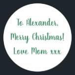 Merry Christmas from Mom green minimal Classic Round Sticker<br><div class="desc">This is a minimal Christmas gift tag label in festive green and white. It has the message Merry Christmas Love Mom xxx in stylish typography script. To personalize, simply change the name Alexander to your loved one's name in the personalize this text box. Want to make more changes? All of...</div>