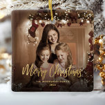 Merry Christmas Gold Script Family Photo Ceramic Ornament<br><div class="desc">Spread holiday cheer to friends and family with this modern keepsake ornament. The gold faux foil text reads "Merry Christmas" in elegant handwriting script. Replace the sample image with your favourite photo,  and add your family name and the year. A black gradient filter helps make the text pop.</div>