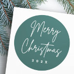 Merry Christmas handwritten script pine green Classic Round Sticker<br><div class="desc">Merry Christmas stickers with the text "Merry Christmas" in a handwritten style script font on a pine green background with the year or custom text below.</div>