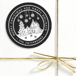 Merry Christmas Happy Holidays Winter Personalized Classic Round Sticker<br><div class="desc">Merry Christmas Happy Holidays Winter Personalized Name Stickers Labels features the text "Merry Christmas and Happy Holidays" in modern white script on a black background and personalized with your name surrounding a home with Christmas trees and snowflakes. Perfect for Christmas party favours and Holiday gifts or in the office for...</div>