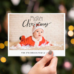 Merry Christmas modern simple photo Holiday Postcard<br><div class="desc">Send this simple and modern Christmas postcard to your family and friends. This Christmas card is personalizable by adding one of your favourite photos, your family name, and year, and features a trendy overlay text that reads "Merry Christmas" in modern handwritten fonts. The back of the card is customizable with...</div>