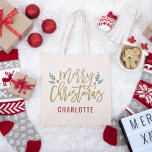Merry Christmas | Monogram Tote Bag<br><div class="desc">Stylish Merry Christmas tote bag design features green branches of holly leaves and red berries accent the antique gold script design. The custom monogram text can be personalized a name or other text.</div>