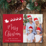 Merry Christmas Photo Santa Holiday Card<br><div class="desc">Festive red holiday card featuring your photo,  a white silhouette of reindeers flying Santa's sleigh,  "Merry Christmas" in a stylish white script and your name in simple modern white typography.</div>