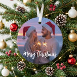 Merry Christmas Romantic Sparkler Couple Photo Ornament<br><div class="desc">This design features a romantic custom photo with elegant Merry Christmas script for a warm and memorable holiday look. The Santa hats, glowing sparklers, and sunset background create a cozy seasonal feel that highlights love and togetherness. It is a lovely choice for couples celebrating a first holiday together, a newlywed...</div>