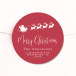 Merry Christmas Santas Sleigh Red Return Address Classic Round Sticker<br><div class="desc">Fun seasonal red sticker for your Christmas holiday cards and correspondence featuring a white silhouette of reindeers flying Santa's sleigh through air,  "Merry Christmas" in a stylish white script and your family name and address in simple modern white typography.</div>