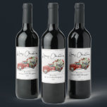 Merry Christmas Vintage Red Truck Family Holiday  Wine Label<br><div class="desc">Merry Christmas Vintage Red Truck Family Holiday Wine Labels - feature a red vintage truck filled with Christmas botanicals, holly berries and a black and white bow on a white weathered wood background. Merry Christmas is in a pretty script font. Label is personalized with your family name. Labels are part...</div>