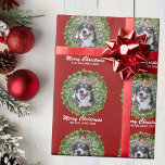 Merry Christmas Wreath Custom Dog Photo Red Wrapping Paper<br><div class="desc">Beautiful custom pet Christmas wrapping paper featuring a green holiday wreath on a red background. Replace with your dog's photo in the centre of the wreath or add a personalized cat picture for your friends and family. Merry Christmas is written in white. Customize with your own text underneath.</div>