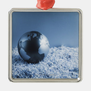 Metal globe on shredded paper ornament