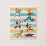Mickey & Friends Retro Stars and Stripes Graphic Jigsaw Puzzle<br><div class="desc">Get ready for adventure with the whole crew! This vibrant "Mickey and Friends" design features the iconic Fab Five—Mickey, Minnie, Donald, Goofy, and Pluto—striding forward in a classic, retro art style. Accented with playful stars and a backdrop of stylish, muted stripes, this graphic captures the timeless joy of Disney friendship....</div>