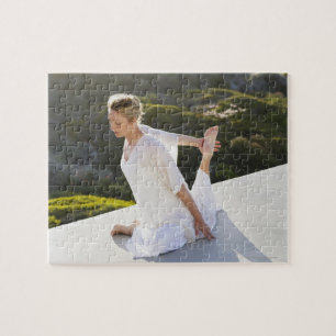 Mid adult woman practicing yoga exercise at jigsaw puzzle