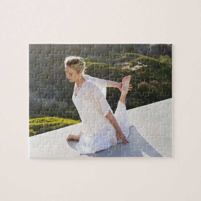 Mid adult woman practicing yoga exercise at jigsaw puzzle (Horizontal)