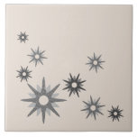 Mid-Century Modern Starburst Silver Ceramic Tile<br><div class="desc">Mid-century modern inspired design featuring vintage retro starbursts in shades of silver grey on a light background. Simple,  clean modern design.</div>
