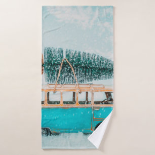 Miniature antique car carrying christmas tree on r bath towel