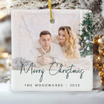 Minimal Photo Merry Christmas Green Script Ceramic Ornament<br><div class="desc">Wish family and friends as special Merry Christmas with this modern minimalist photo keepsake ornament. The dark green text reads "Merry Christmas" in trendy handwriting script. Easily replace the sample image with your favourite photo, and add your family name or first names and the year below. A white gradient screen...</div>