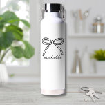 Minimalist Hand Drawn Bow Name Water Bottle<br><div class="desc">Simple Name Monogram Minimalist Water Bottle. This cute and stylish water bottle features a large hand-drawn bow at the top, paired with a name in elegant handwritten script calligraphy below. The design is displayed prominently, creating a trendy yet timeless look. Both the bow and the name are black by default...</div>