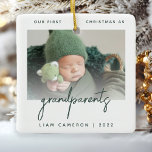 Minimalist Photo Grandparents 1st Christmas Green Ceramic Ornament<br><div class="desc">Help them celebrate the arrival of their first grandchild with this modern minimalist photo keepsake ornament. The dark green text reads "Our first Christmas as grandparents, " with the word "grandparents" in trendy handwriting script. Easily replace the sample image with your favorite photo, and add baby's name and the year...</div>
