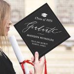 Minimalist Simple Graduate Script Class of 2025 Graduation Cap Topper<br><div class="desc">Mark your special day with this classic cap topper design! The script lettering stands out beautifully against the dark background,  offering a touch of refined elegance. You can easily tailor the text,  fonts,  and colours to suit your style using Zazzle's intuitive tools.</div>
