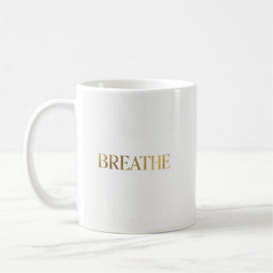 Minimalist typography with gold word breathe coffee mug