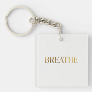 Minimalist typography with gold word breathe keychain
