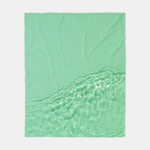 Mint blue coloured clear water surface texture wit fleece blanket