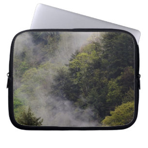 Mist rising from mountainside after spring rain, laptop sleeve