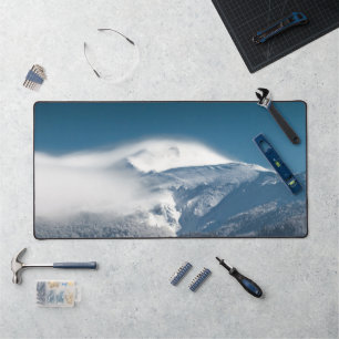Misty clouds over snowy mountain Snežnik, Slovenia Desk Mat