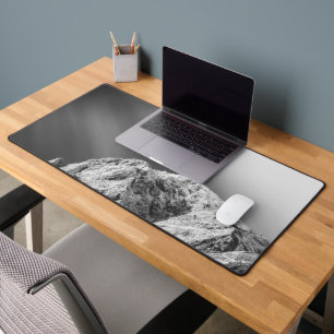 Misty clouds over the mountains in black and white desk mat