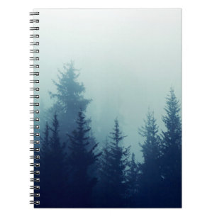 Misty fog in pine forest on mountain slopes. Colou Notebook
