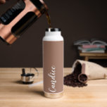 Mocha Personanlized Wedding Bridesmaid Water Bottle<br><div class="desc">Gift your wedding bridesmaid or maid of honour with this trendy, vacuum Insulated water bottle that features her name in white, stylized script on a trendy mocha brown colour background designed to match your wedding colour scheme. Personalize bottle by editing and replacing name with your own as desired. Select your...</div>