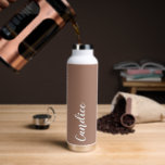 Mocha Personanlized Wedding Bridesmaid Water Bottle<br><div class="desc">Gift your wedding bridesmaid or maid of honour with this trendy, vacuum Insulated water bottle that features her name in white, stylized script on a trendy mocha brown colour background designed to match your wedding colour scheme. Personalize bottle by editing and replacing name with your own as desired. Select your...</div>